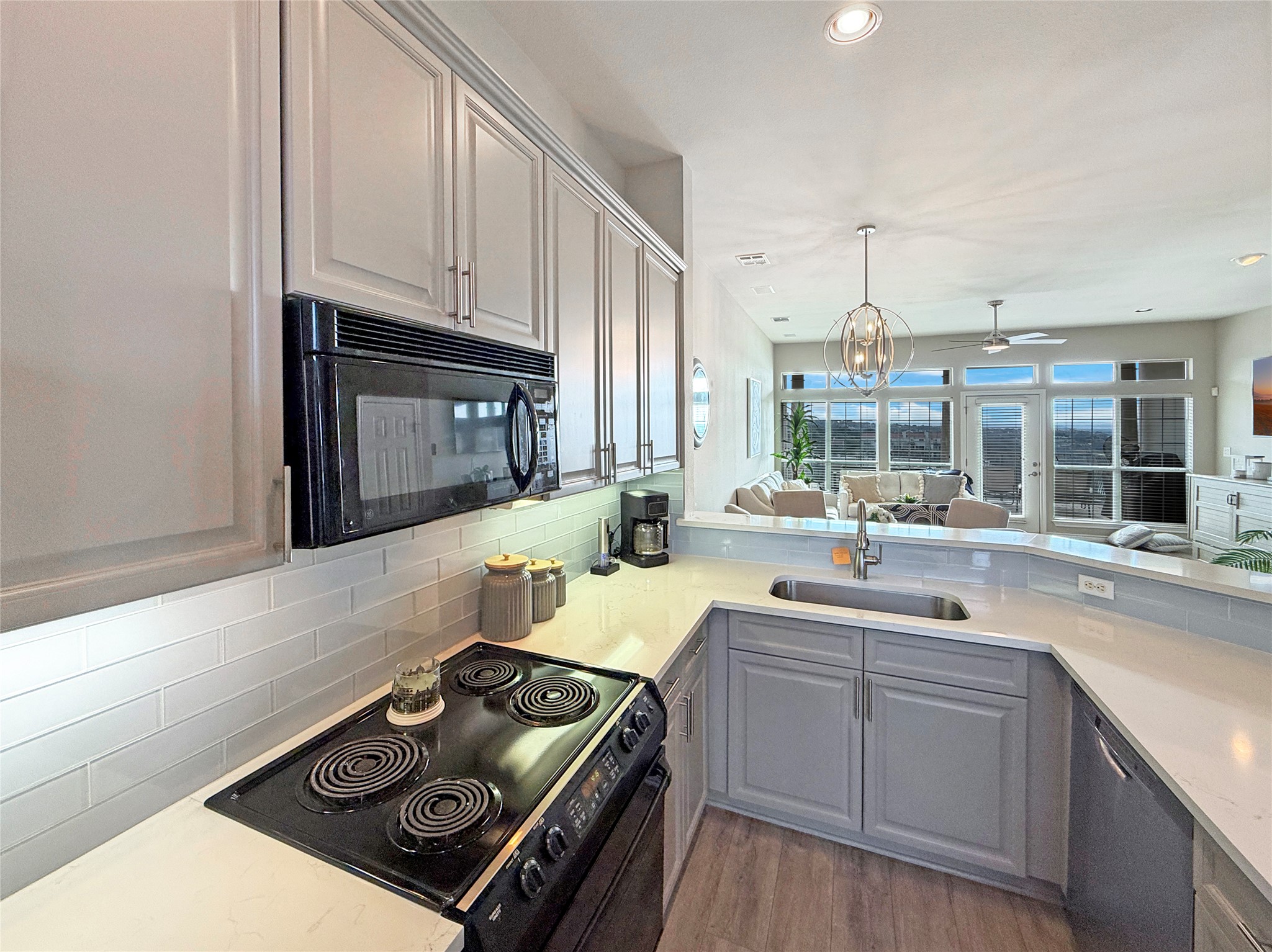 2918 Ranch Road 620 North, Unit Y199 Austin, TX 78734 - Photo 8 of 39 a kitchen with a stove a sink and cabinets