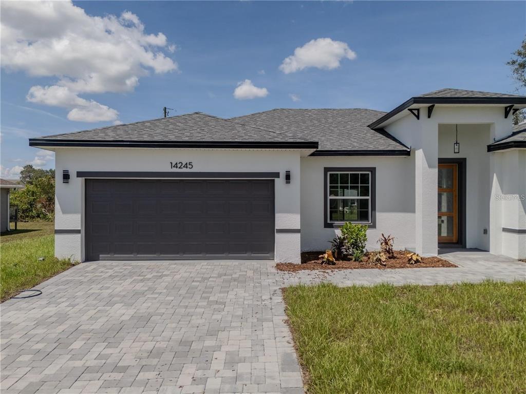 14245 Southwest 28th Court Ocala, FL 34473 - Photo 2 of 84 a front view of a house with a yard