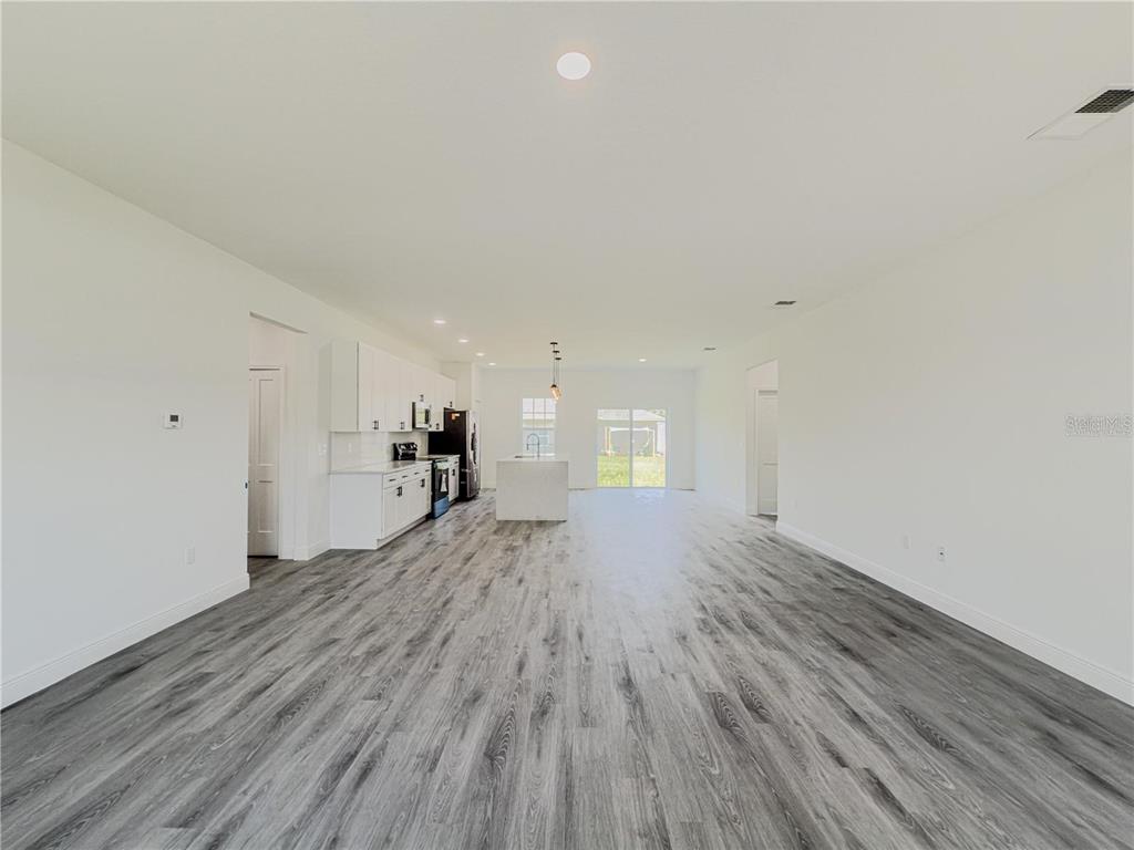 14245 Southwest 28th Court Ocala, FL 34473 - Photo 22 of 84 a view of empty room with wooden floor and window