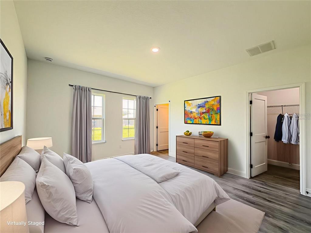 14245 Southwest 28th Court Ocala, FL 34473 - Photo 27 of 84 a bedroom with a bed and wooden floor