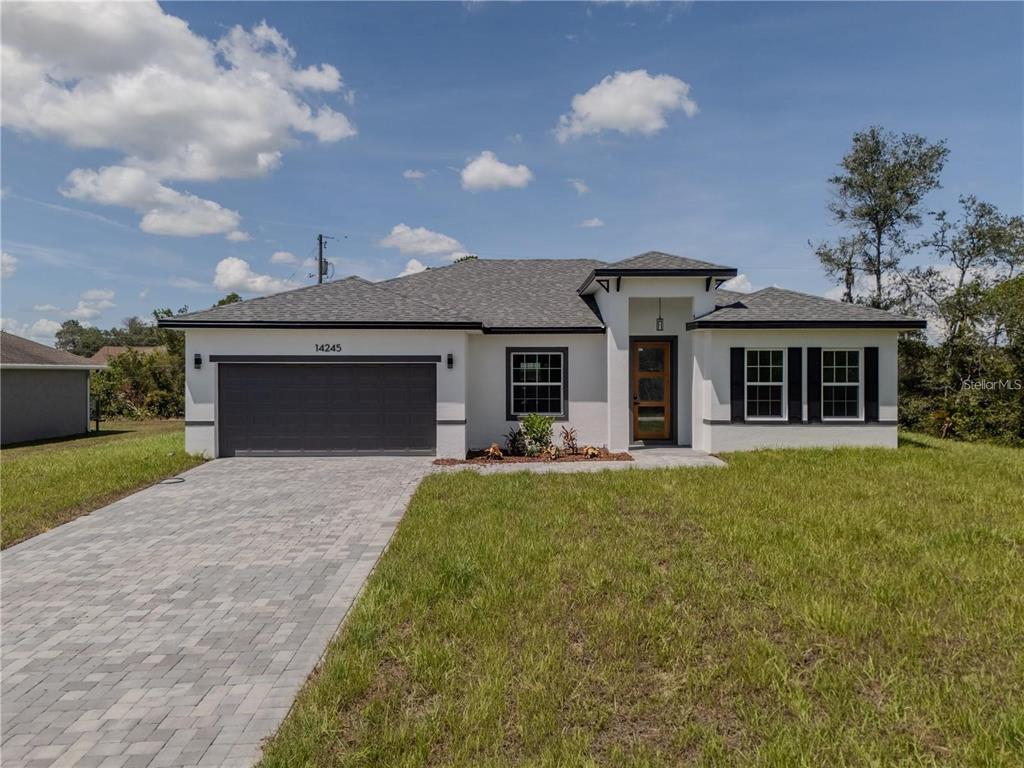 14245 Southwest 28th Court Ocala, FL 34473 - Photo 3 of 84 a front view of a house with a garden and yard