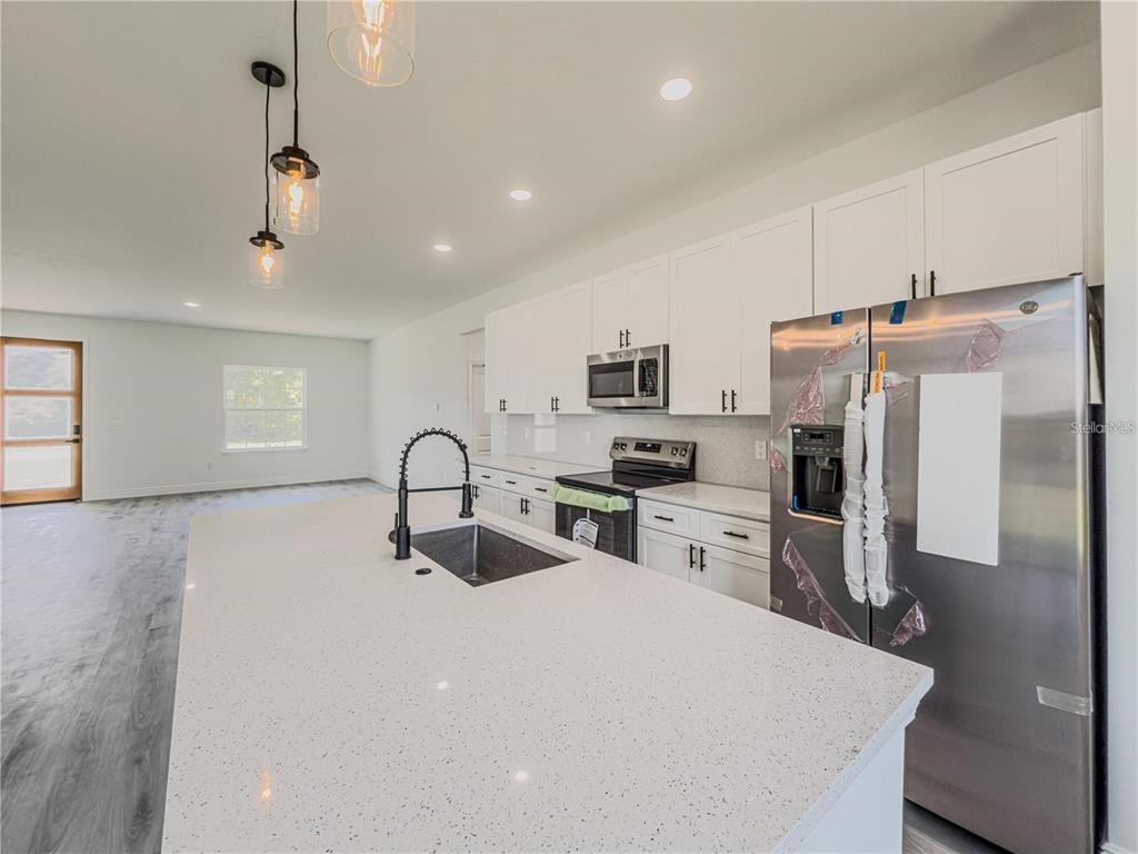 14245 Southwest 28th Court Ocala, FL 34473 - Photo 32 of 84 a kitchen with stainless steel appliances a refrigerator sink and stove