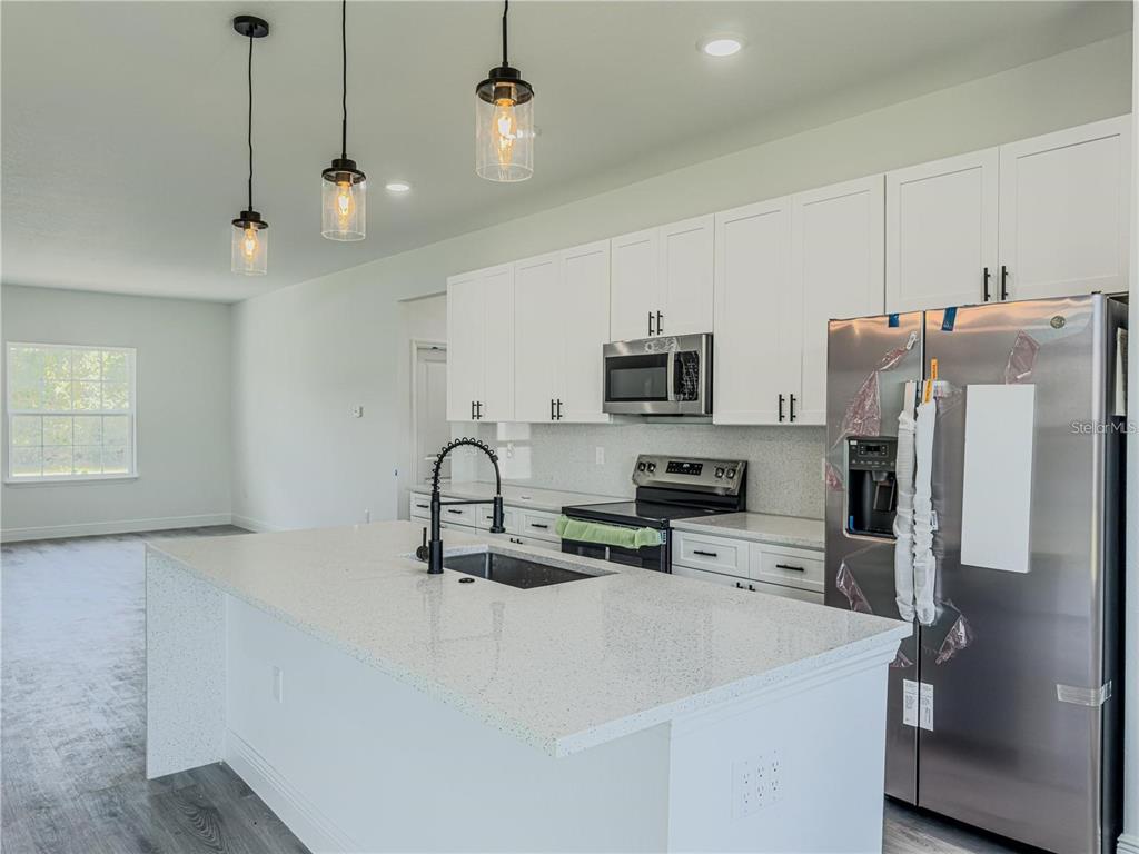 14245 Southwest 28th Court Ocala, FL 34473 - Photo 36 of 84 a kitchen with stainless steel appliances a refrigerator sink and microwave