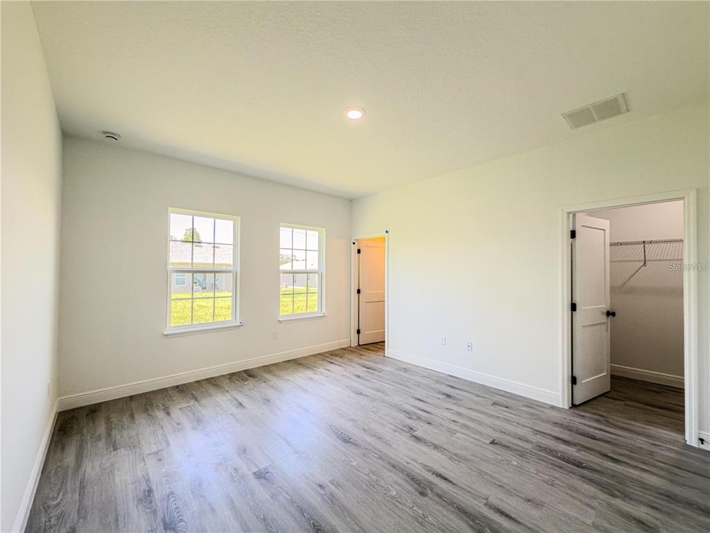 14245 Southwest 28th Court Ocala, FL 34473 - Photo 46 of 84 a view of an empty room with window and wooden floor