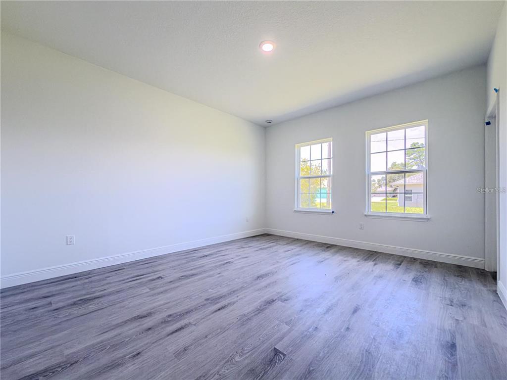 14245 Southwest 28th Court Ocala, FL 34473 - Photo 47 of 84 an empty room with wooden floor and windows