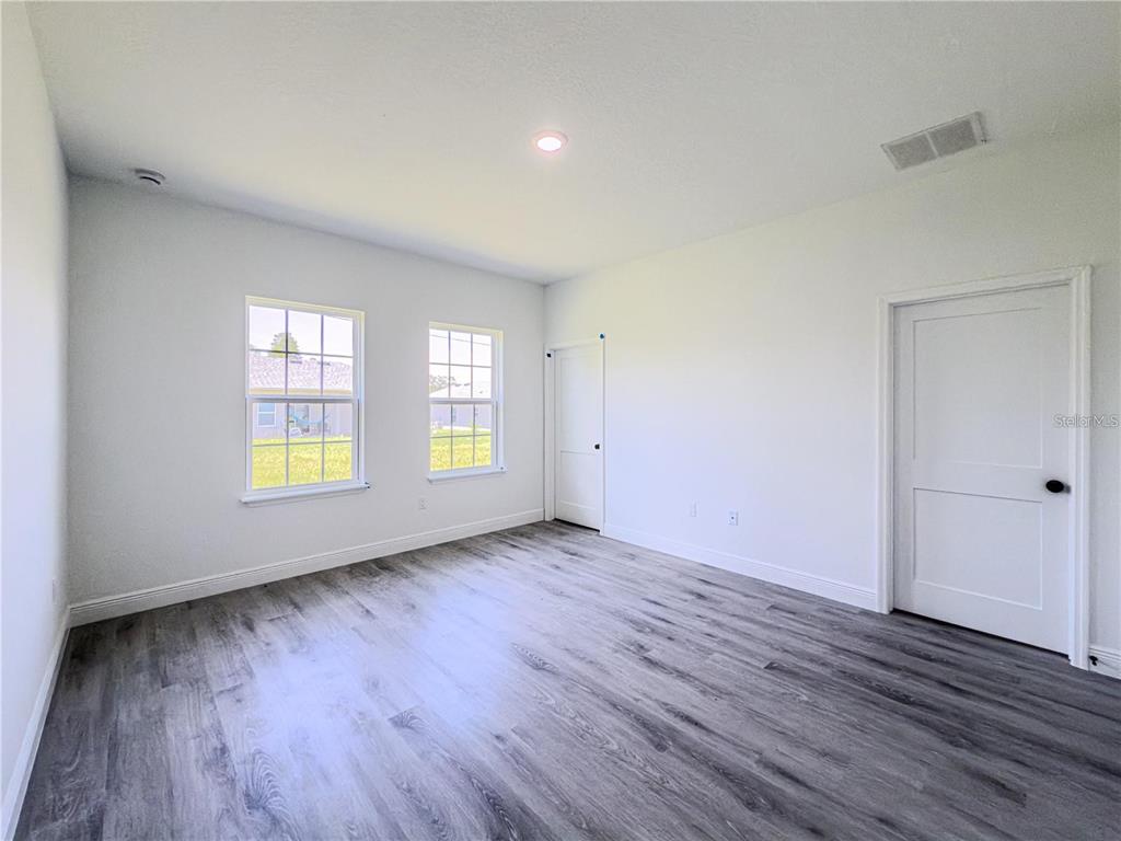 14245 Southwest 28th Court Ocala, FL 34473 - Photo 48 of 84 an empty room with wooden floor and windows
