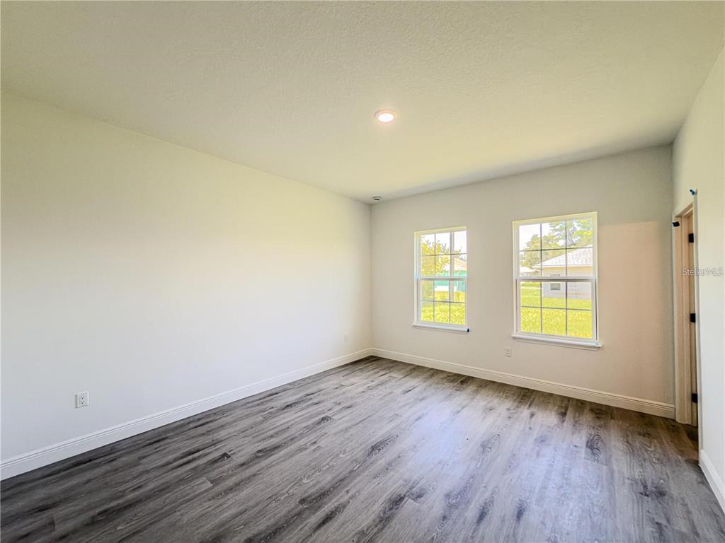 14245 Southwest 28th Court Ocala, FL 34473 - Photo 50 of 84 an empty room with wooden floor and windows