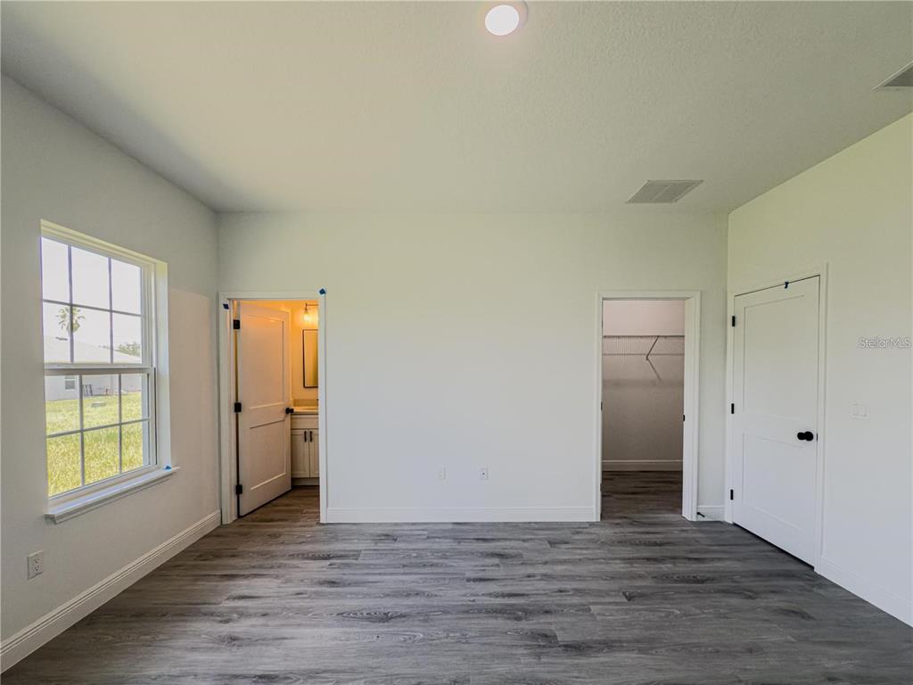 14245 Southwest 28th Court Ocala, FL 34473 - Photo 52 of 84 a view of an empty room with window and wooden floor