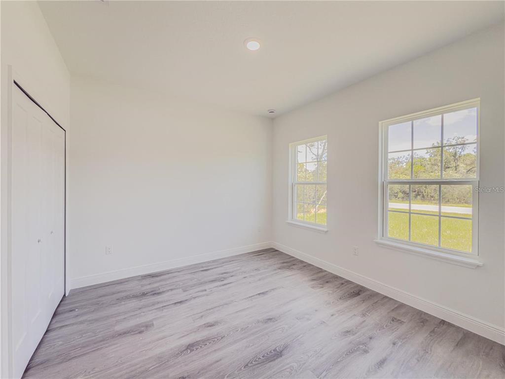 14245 Southwest 28th Court Ocala, FL 34473 - Photo 53 of 84 an empty room with wooden floor and windows