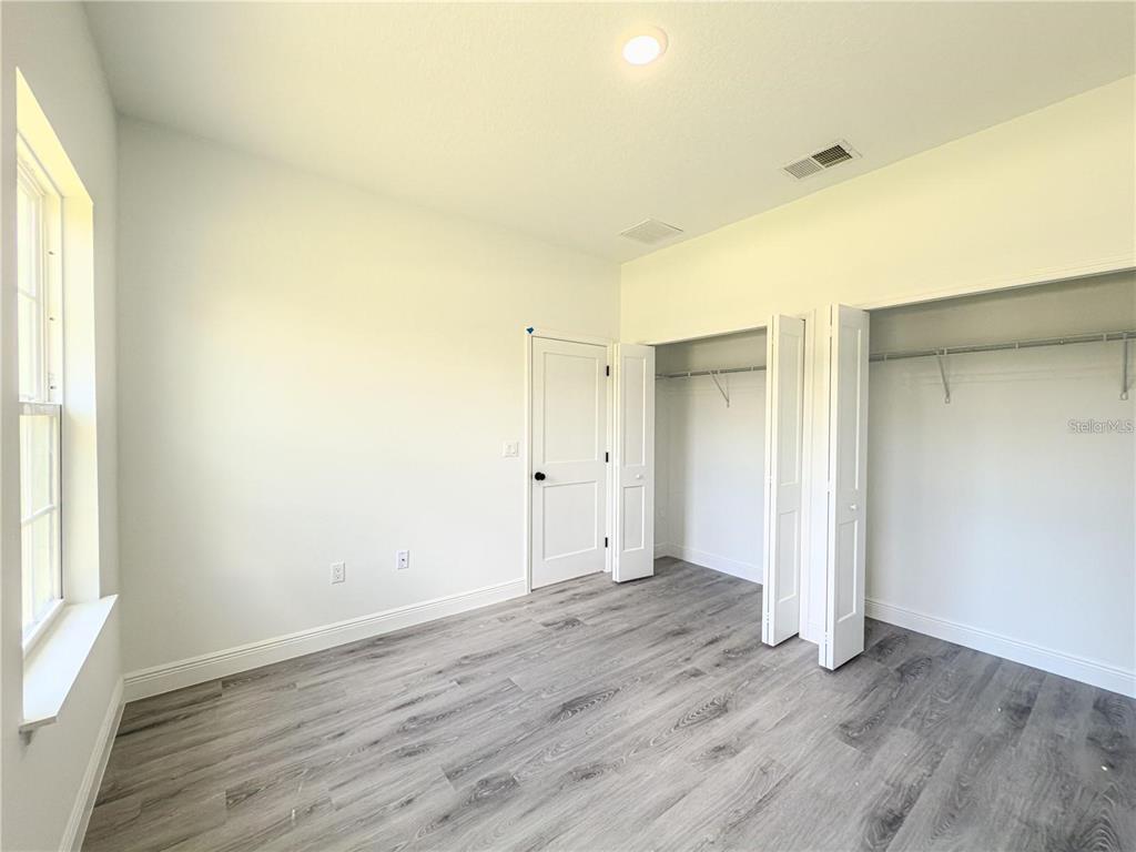 14245 Southwest 28th Court Ocala, FL 34473 - Photo 56 of 84 an empty room with wooden floor and windows