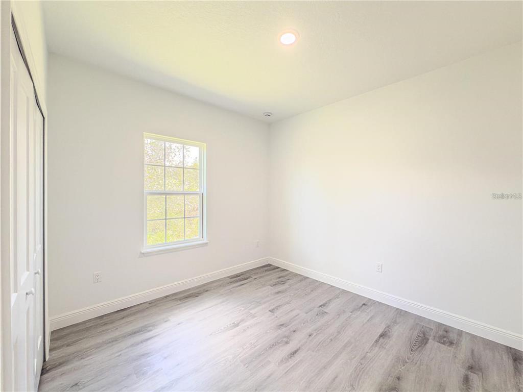 14245 Southwest 28th Court Ocala, FL 34473 - Photo 59 of 84 an empty room with wooden floor and windows