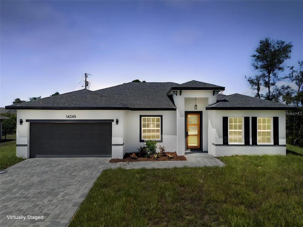 14245 Southwest 28th Court Ocala, FL 34473 - Photo 6 of 84 a front view of a house with a yard and garage