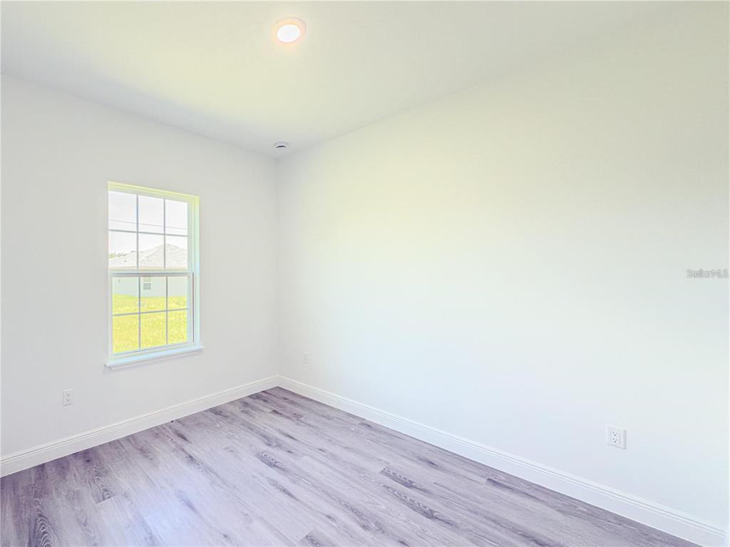 14245 Southwest 28th Court Ocala, FL 34473 - Photo 62 of 84 an empty room with a window and wooden floor