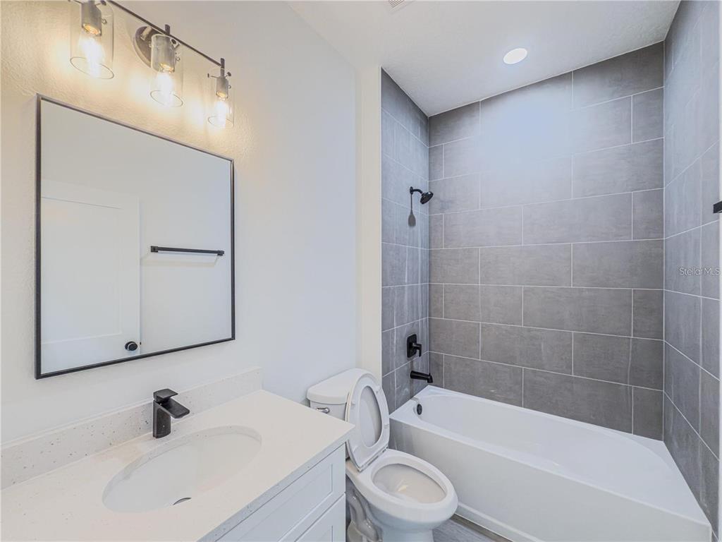 14245 Southwest 28th Court Ocala, FL 34473 - Photo 68 of 84 a bathroom with a sink a toilet and shower