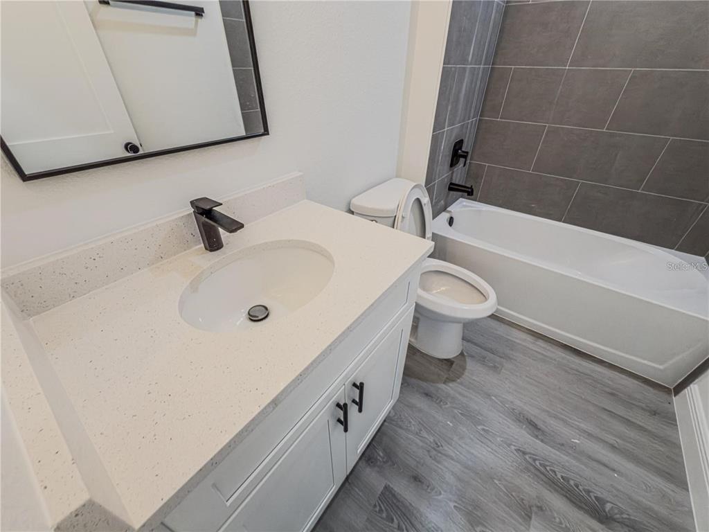 14245 Southwest 28th Court Ocala, FL 34473 - Photo 71 of 84 a bathroom with a sink a toilet and bathtub