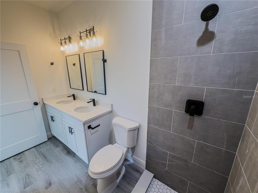 14245 Southwest 28th Court Ocala, FL 34473 - Photo 74 of 84 a bathroom with a toilet a sink and mirror