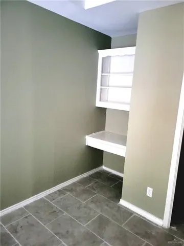 a view of room with window and a ceiling fan