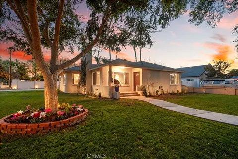 a front view of a house with a yard table and chairs