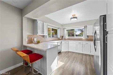 a kitchen with cabinets and wooden floor