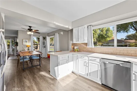 a kitchen with cabinets and chairs