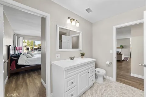 a en suite bathroom with a toilet sink and mirror