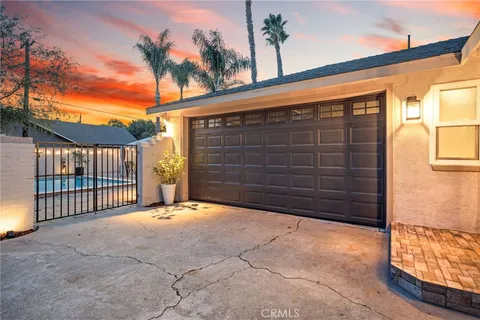 a view of a house with a wooden fence