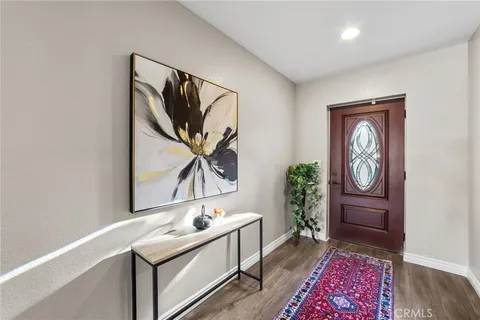 a hallway with a large mirror and a dresser