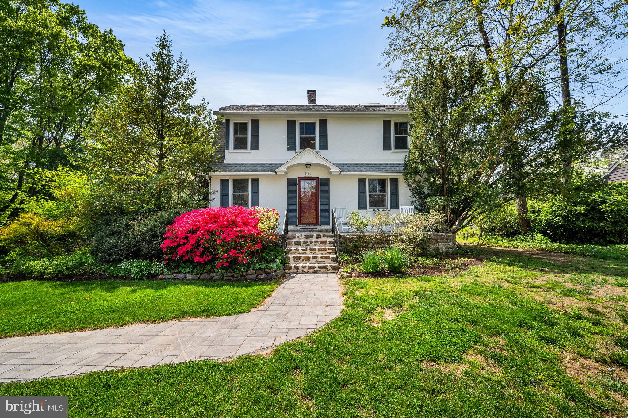 320 Riverview Road Swarthmore, PA 19081 - Photo 2 of 38 a front view of a house with a yard and garage