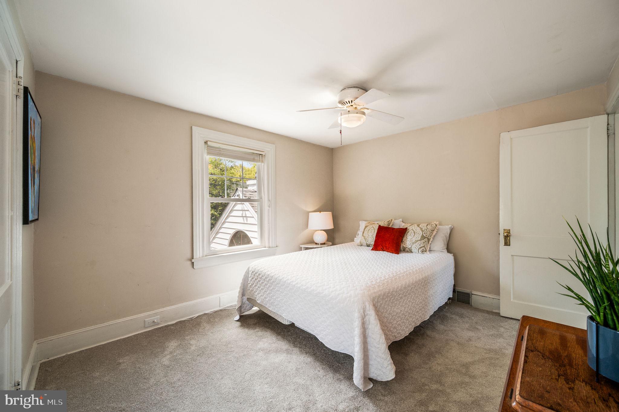 320 Riverview Road Swarthmore, PA 19081 - Photo 23 of 38 a bedroom with a bed chandelier and a window
