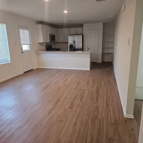 a view of a kitchen with microwave and cabinets