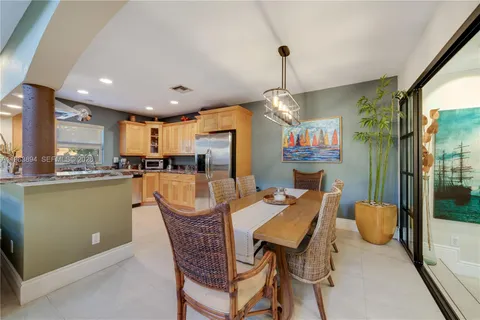 a view of a dining room and livingroom with furniture wooden floor a chandelier