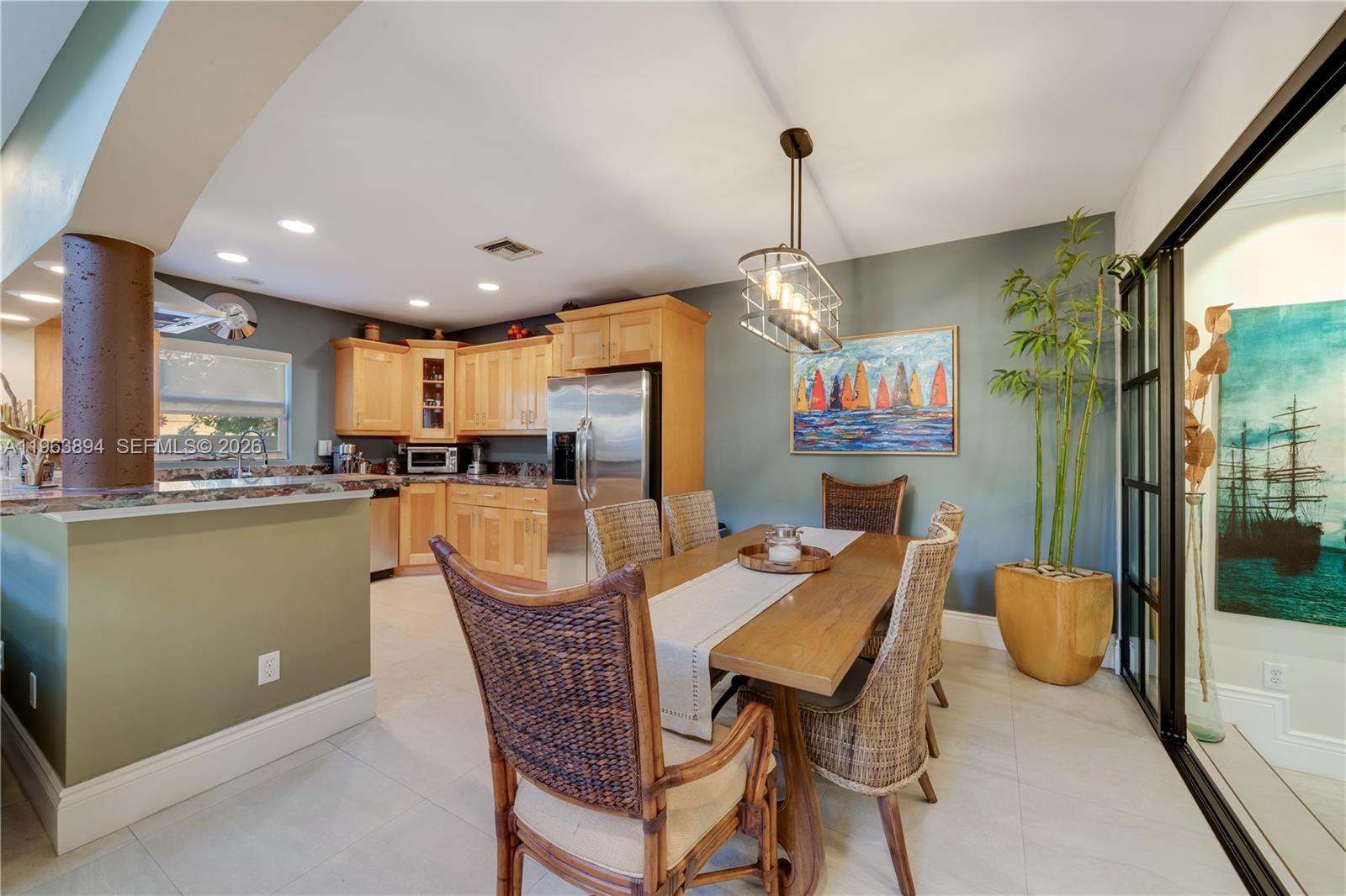 3197 Virginia Street Miami, FL 33133 - Photo 8 of 22 a view of a dining room and livingroom with furniture wooden floor a chandelier
