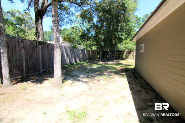 103 Jean Circle Daphne, AL 36526 - Photo 11 of 12 Back Yard is fenced and boasts a large screened porch and double gate for easy access.