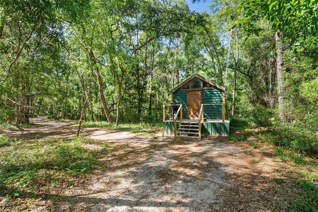 25723 Bareva Road Weeki Wachee, FL 34614 - Photo 27 of 55 a view of a house with a yard and sitting area