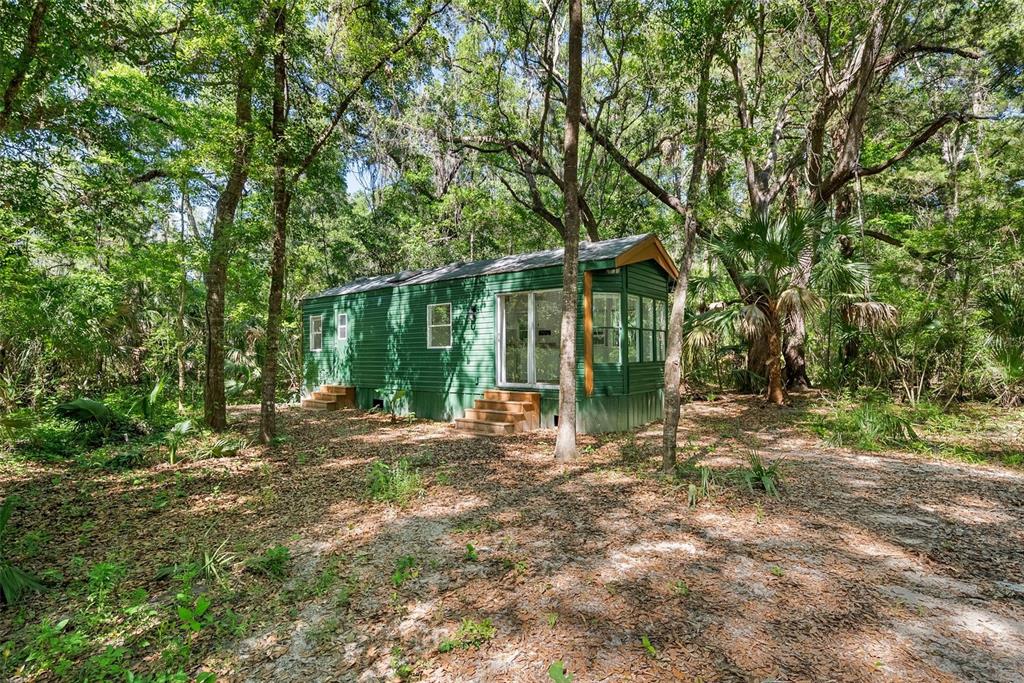 25723 Bareva Road Weeki Wachee, FL 34614 - Photo 28 of 55 a view of a house with backyard and sitting area