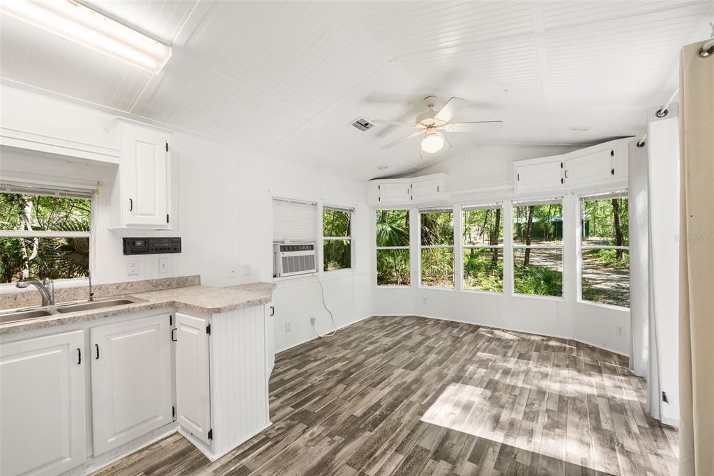 25723 Bareva Road Weeki Wachee, FL 34614 - Photo 32 of 55 a view of a kitchen with a sink dishwasher a fireplace with wooden floor