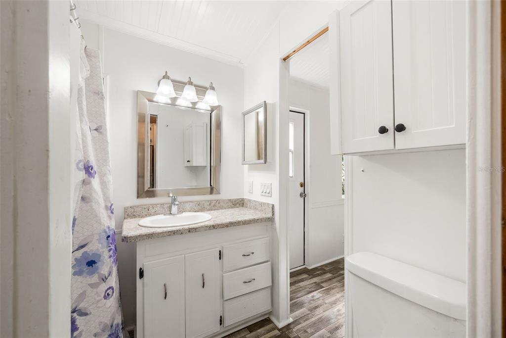 25723 Bareva Road Weeki Wachee, FL 34614 - Photo 33 of 55 a bathroom with a granite countertop sink a toilet and a mirror