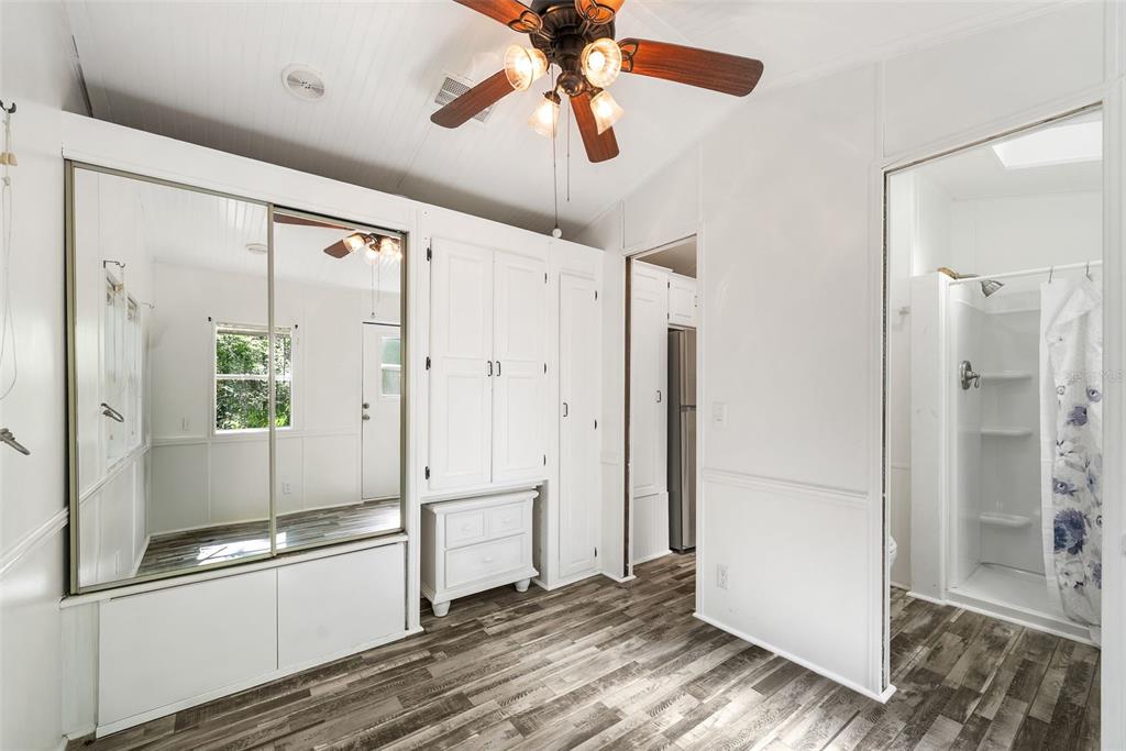 25723 Bareva Road Weeki Wachee, FL 34614 - Photo 35 of 55 a view of a hallway with wooden floor and a chandelier fan