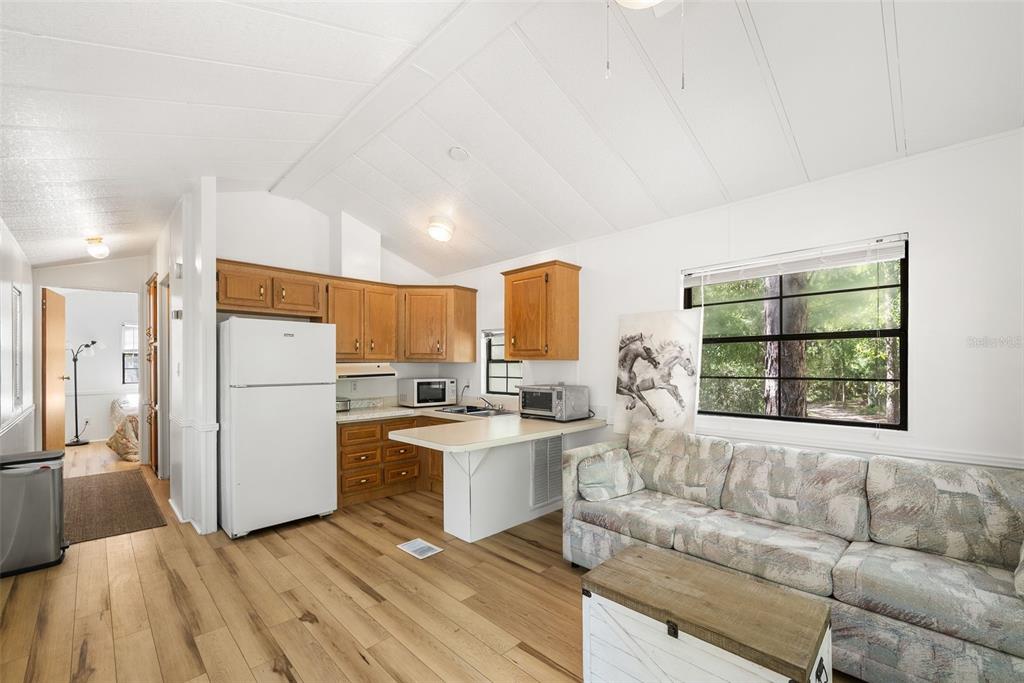 25723 Bareva Road Weeki Wachee, FL 34614 - Photo 36 of 55 a living room with stainless steel appliances furniture and a large window