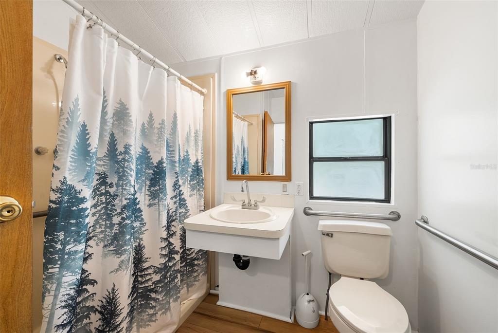 25723 Bareva Road Weeki Wachee, FL 34614 - Photo 39 of 55 a bathroom with a toilet sink and mirror