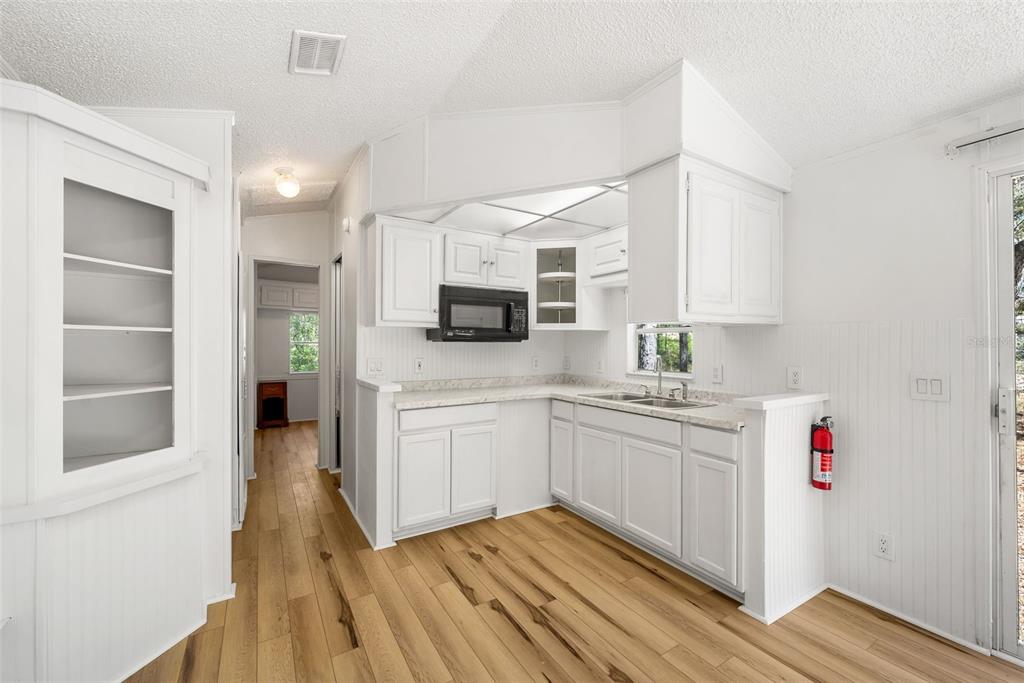 25723 Bareva Road Weeki Wachee, FL 34614 - Photo 41 of 55 a kitchen with granite countertop white cabinets and white appliances
