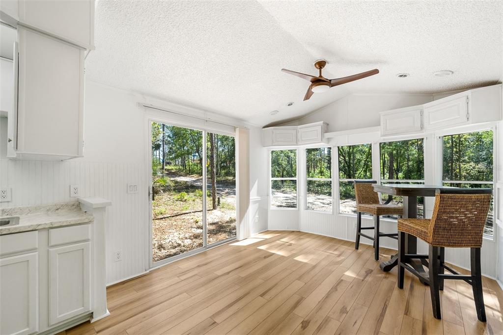 25723 Bareva Road Weeki Wachee, FL 34614 - Photo 42 of 55 a view of a kitchen with a table and chairs