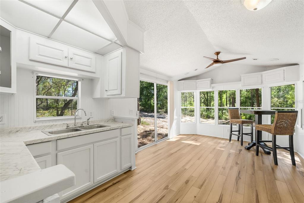 25723 Bareva Road Weeki Wachee, FL 34614 - Photo 43 of 55 a kitchen with a table chairs and wooden floor
