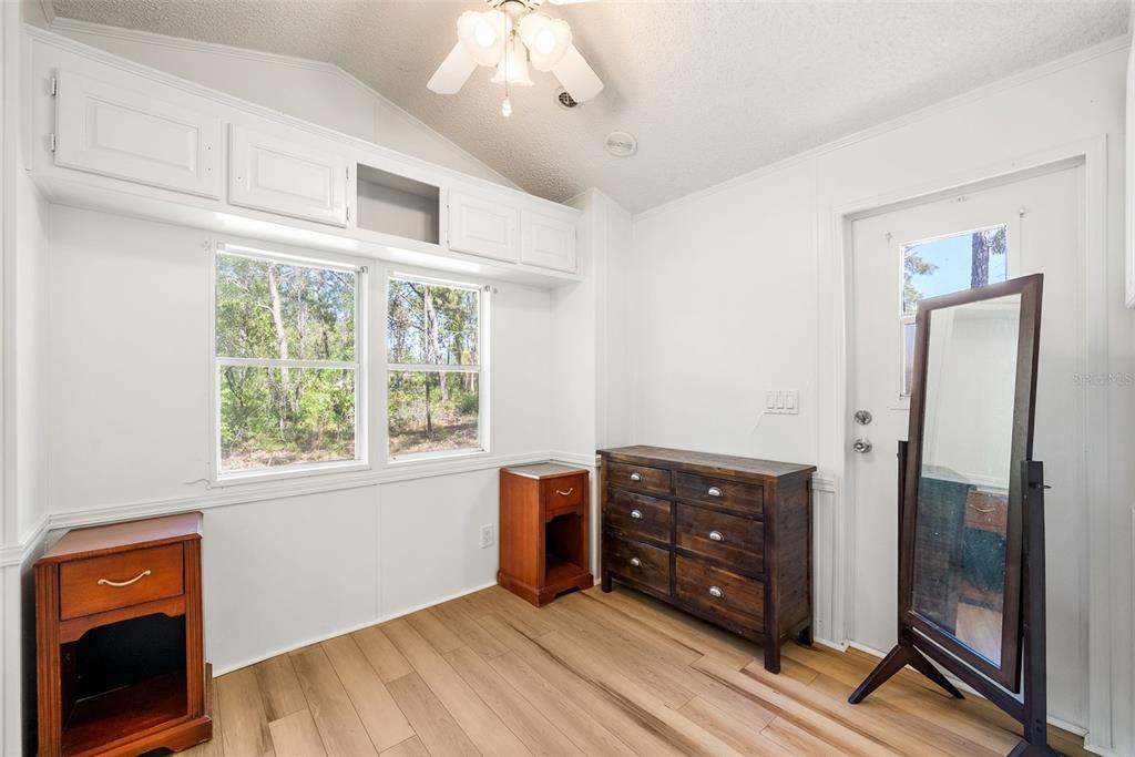25723 Bareva Road Weeki Wachee, FL 34614 - Photo 45 of 55 a view of an empty room with wooden floor and a window