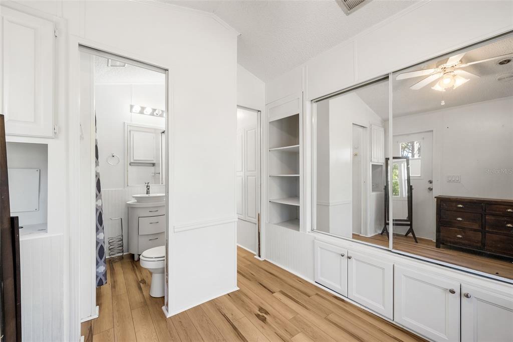 25723 Bareva Road Weeki Wachee, FL 34614 - Photo 46 of 55 a view of walk in closet with wooden floor