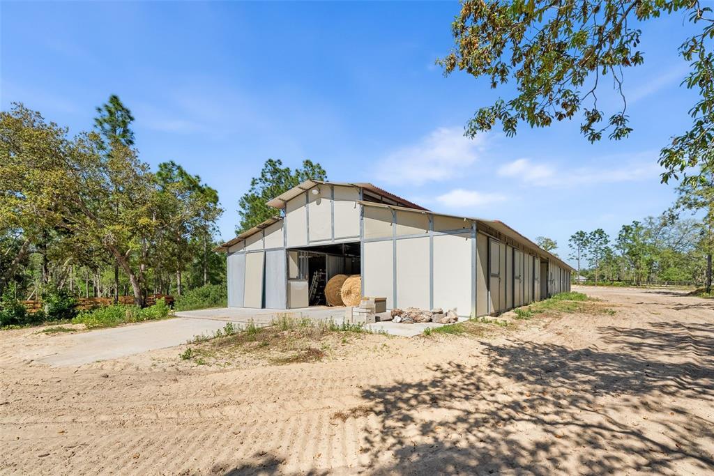 25723 Bareva Road Weeki Wachee, FL 34614 - Photo 8 of 55 a view of large house with a yard