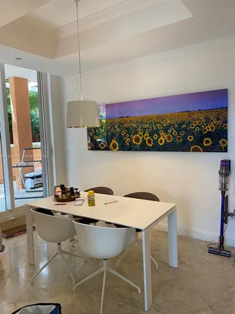 a view of a dining room with furniture and a floor to ceiling window
