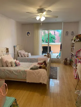 a bedroom with furniture and a large window