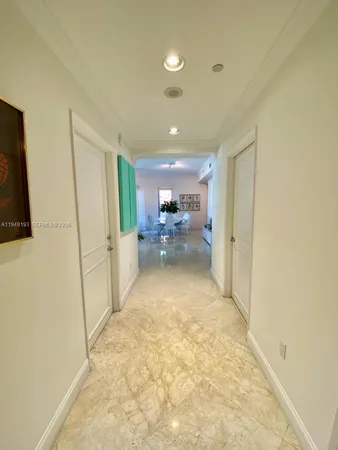 a view of a hallway to a livingroom and furniture