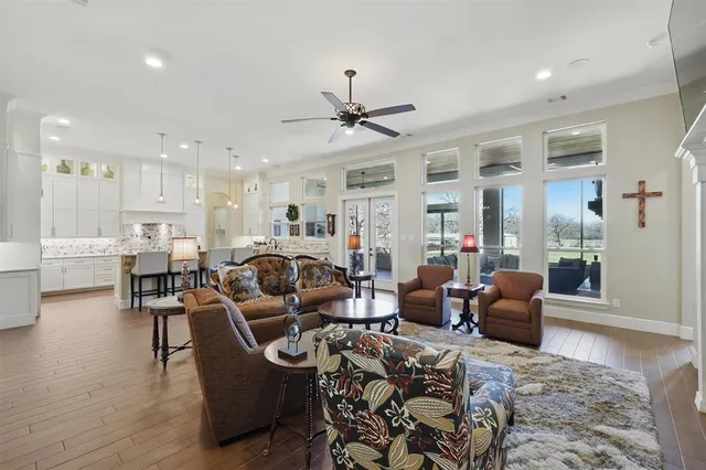a living room with furniture a fireplace and a chandelier
